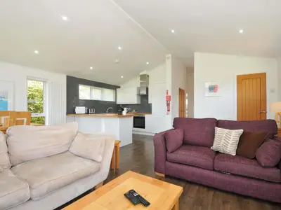 a living room with a couch and a table at 3 Horizon View in Liskeard