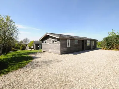 a house on a gravel driveway with a garage at 4 Horizon View in Liskeard