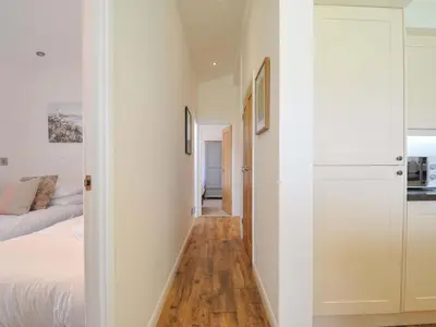 a hallway leading to a bedroom with a bed at 8 Horizon View in Liskeard