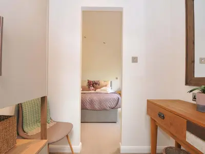 a bedroom with a bed and a mirror at 8 Horizon View in Liskeard
