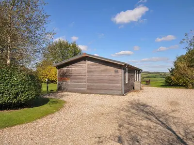 a small shed sitting on top of a gravel driveway at 8 Horizon View in Liskeard