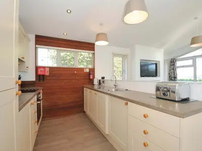 a kitchen with white cabinets and a counter top at 10 Horizon View in Liskeard