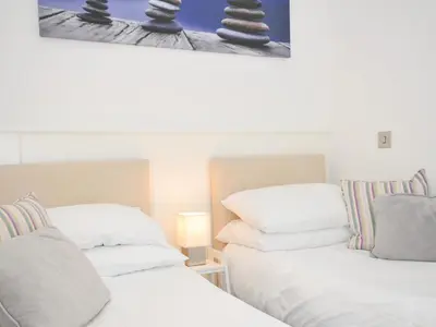 two beds sitting next to each other in a room at 9 Horizon View in Liskeard