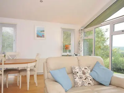 a living room with a couch and a table at 11 Horizon View in Liskeard