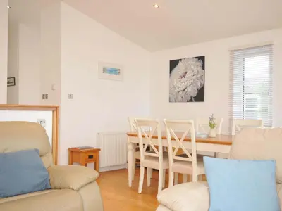 a kitchen and dining room with a table and chairs at 11 Horizon View in Liskeard