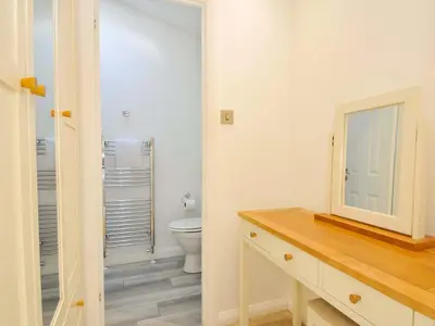 a bathroom with a toilet and a sink and a mirror at 11 Horizon View in Liskeard