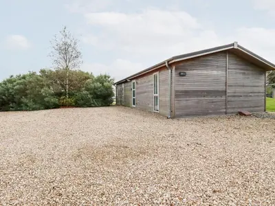 a wooden building with a gravel yard at 11 Horizon View in Liskeard