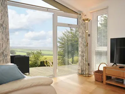 a living room with a large sliding glass door at 11 Horizon View in Liskeard