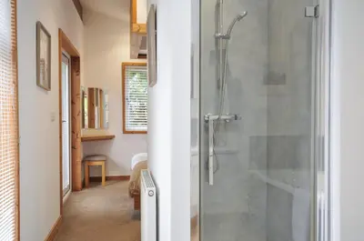 a bathroom with a shower with a glass door at 3 Southern Place in Liskeard