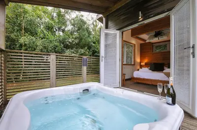 a bath tub in a room with a bedroom at 3 Southern Place in Liskeard
