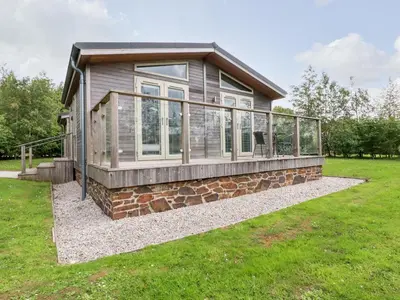 a home with a wrap around porch on a grass field at 6 Southern Place in Liskeard