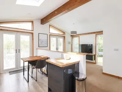 a kitchen with a counter and a table and chairs at 6 Southern Place in Liskeard