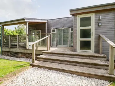 a house with a wooden porch and a door at 6 Southern Place in Liskeard