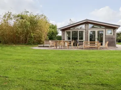 a pavilion with a table and benches in a field at 14 Horizon View in Liskeard
