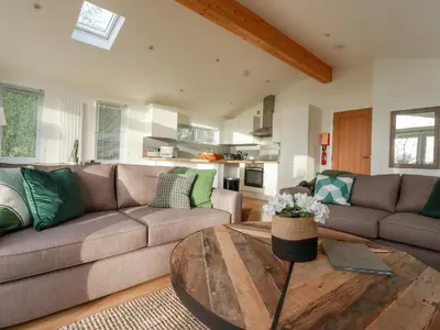 a living room with a couch and a table at 14 Horizon View in Liskeard