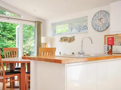 a kitchen with a sink and a clock on the wall at 15 Horizon View in Liskeard
