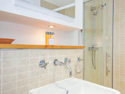 a bathroom with a shower and a sink at 15 Horizon View in Liskeard