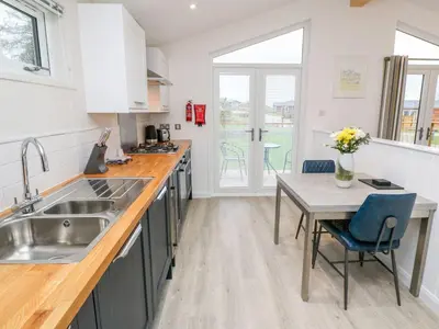 a kitchen with a sink and a table at 4 Faraway Fields in Liskeard