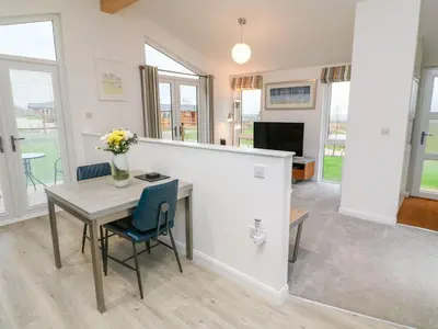 a dining room with a table and chairs at 4 Faraway Fields in Liskeard