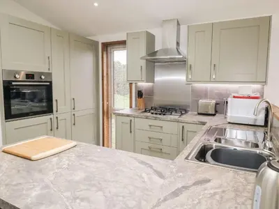a kitchen with a sink and a counter top at 2 Meadow Retreat in Liskeard