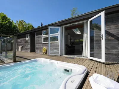 a hot tub on the deck of a house at 5 Meadow Retreat in Liskeard