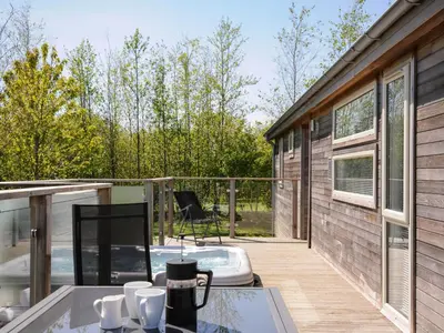 a screened in porch with a hot tub on a deck at 7 Meadow Retreat in Liskeard
