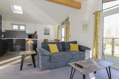 a living room with a couch and a table at 11 Meadow Retreat in Liskeard