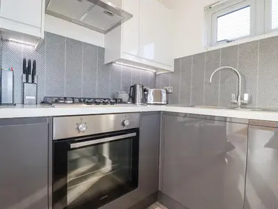 a kitchen with a stainless steel oven and a sink at 11 Meadow Retreat in Liskeard