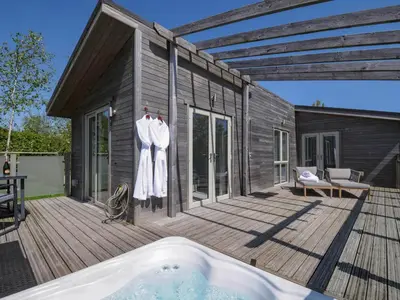 a wooden deck with a hot tub on a house at 11 Meadow Retreat in Liskeard