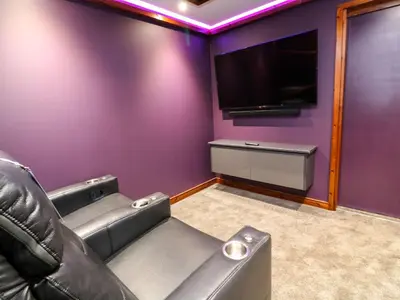 a cinema room with a couch and a flat screen tv at 2 Southern Place in Liskeard