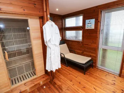a room with a room with a chair and a window at 2 Southern Place in Liskeard
