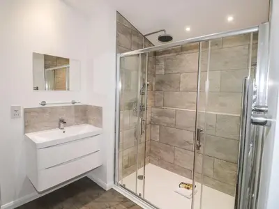 a bathroom with a shower and a sink at 1 Southern Place in Liskeard