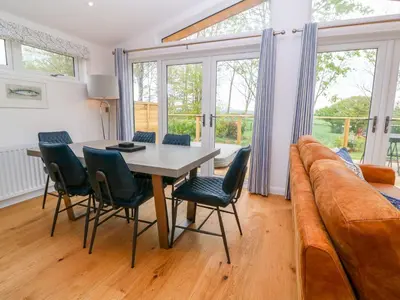 a living room with a table and chairs and a couch at 21 Meadow Retreat in Liskeard