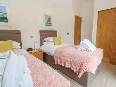 a bedroom with two beds with towels on them at 21 Meadow Retreat in Liskeard