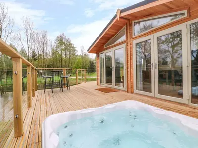 a hot tub on the deck of a house at 21 Meadow Retreat in Liskeard