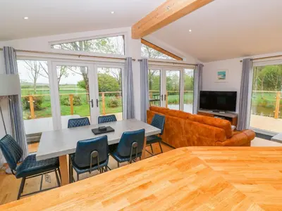 a living room with a table and chairs and a couch at 21 Meadow Retreat in Liskeard