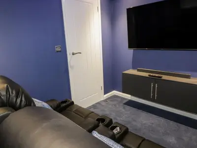 a living room with a couch and a flat screen tv at 19 Meadow Retreat in Liskeard