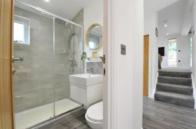 a bathroom with a toilet and a shower and a sink at 24 Meadow Retreat in Liskeard