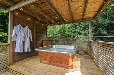 a wooden deck with a bath tub on a wooden floor at 24 Meadow Retreat in Liskeard