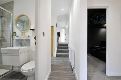 a bathroom with a toilet and a sink and a staircase at 24 Meadow Retreat in Liskeard