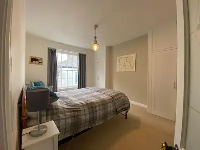 a bedroom with a bed and a tv in it at Clarendon House in Saint Columb Major