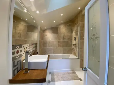 a bathroom with a bath tub and a sink at Clarendon House in Saint Columb Major