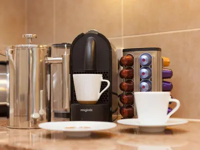 a coffee maker and two cups on a counter at Surf and Sand in St Ives
