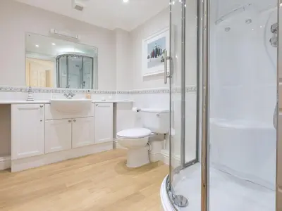 a bathroom with a toilet and a sink and a shower at Surf and Sand in St Ives