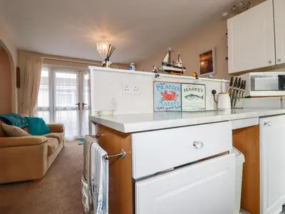 a kitchen with a white counter top in a room at Smugglers in Liskeard