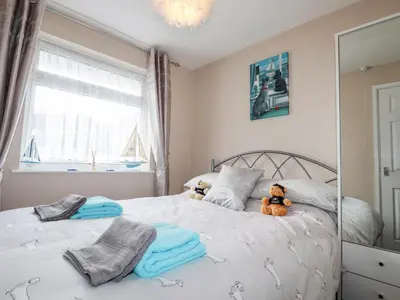 a bedroom with a bed with two teddy bears on it at Smugglers in Liskeard