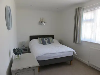 a small bedroom with a bed and a window at The Retreat St Ives in St Ives
