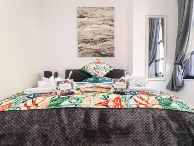 a bedroom with a bed with a colorful blanket at The Dynar in Helston
