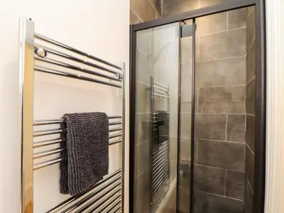 a shower with a glass door in a bathroom at The Dynar in Helston