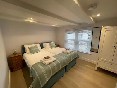 a bedroom with a bed with towels on it at Seasteps Padstow in Padstow